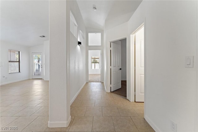 corridor featuring light tile patterned floors