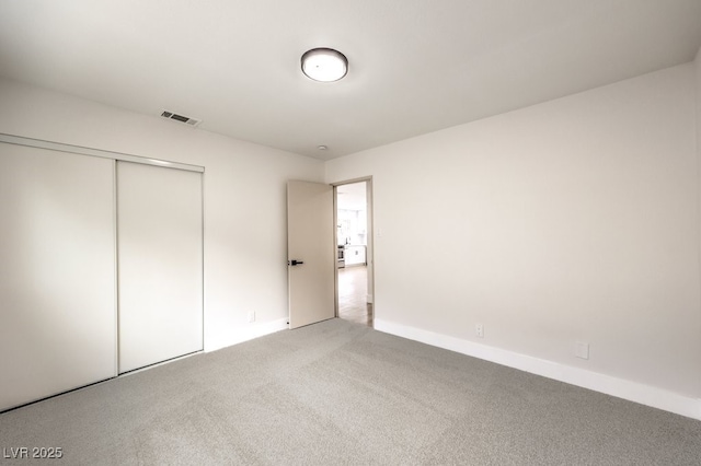 unfurnished bedroom featuring a closet and carpet flooring