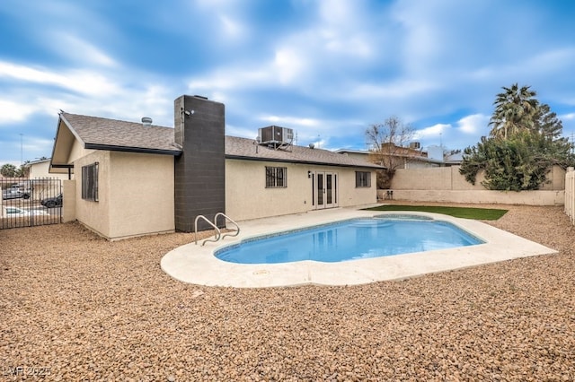 view of swimming pool featuring central AC, a patio, and french doors