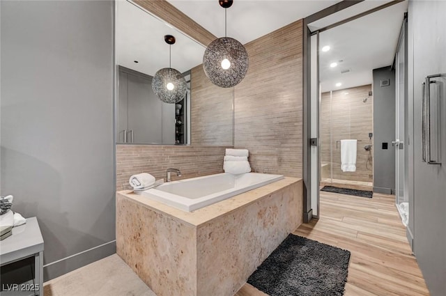 bathroom with hardwood / wood-style flooring and an enclosed shower