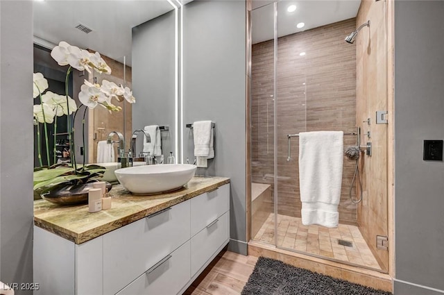 bathroom with an enclosed shower and vanity