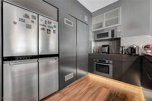 kitchen featuring stainless steel appliances and light hardwood / wood-style floors