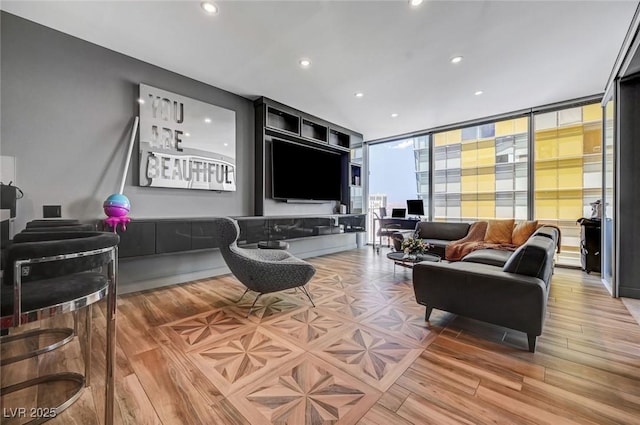 living room with expansive windows and light wood-type flooring