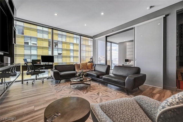 living room featuring hardwood / wood-style flooring and a wall of windows