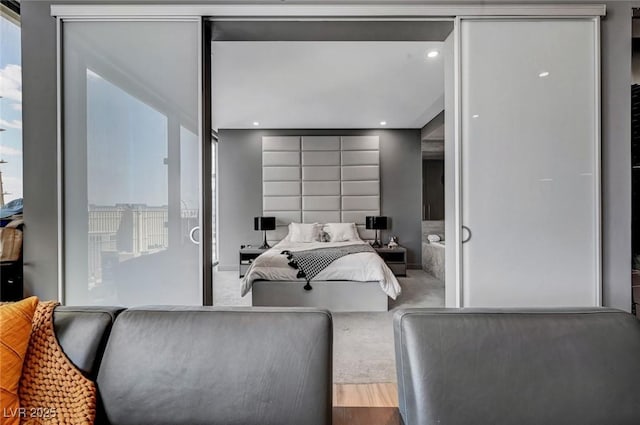 bedroom with wood-type flooring and multiple windows