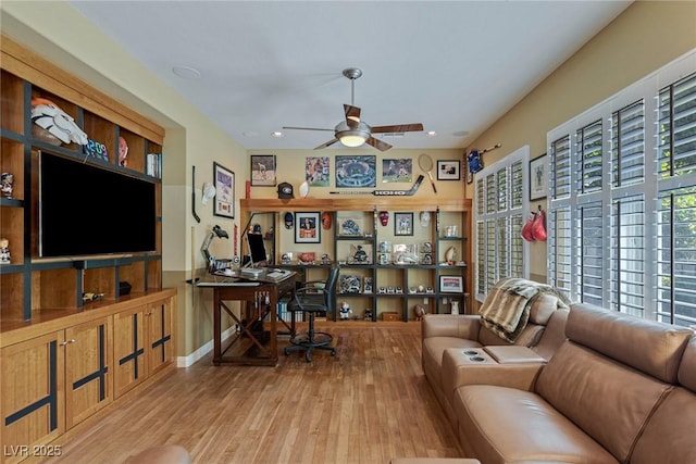 living room featuring ceiling fan and light hardwood / wood-style floors