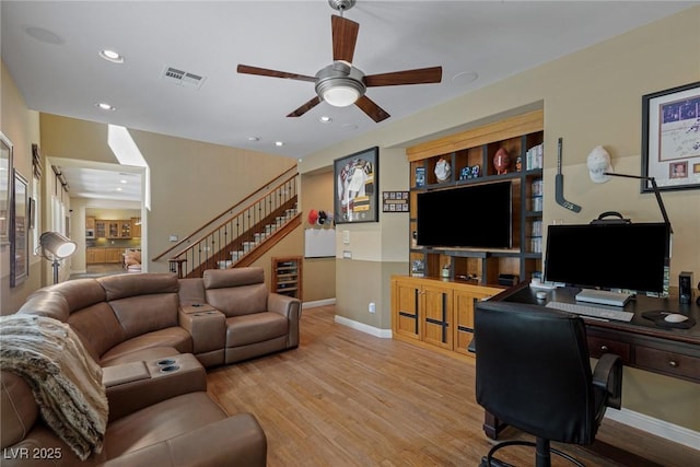 living room featuring ceiling fan and light wood-type flooring