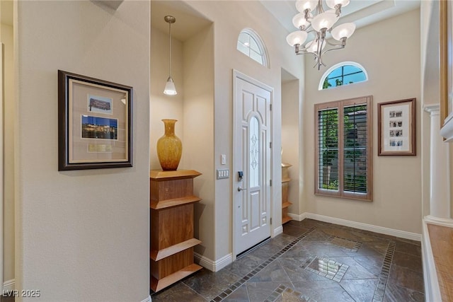 entrance foyer featuring a high ceiling and a notable chandelier