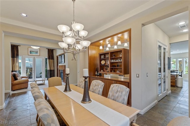 dining room featuring a chandelier and french doors