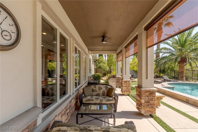 view of patio / terrace with a fenced in pool and ceiling fan