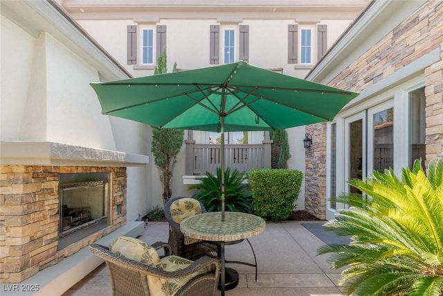 view of patio / terrace featuring an outdoor stone fireplace