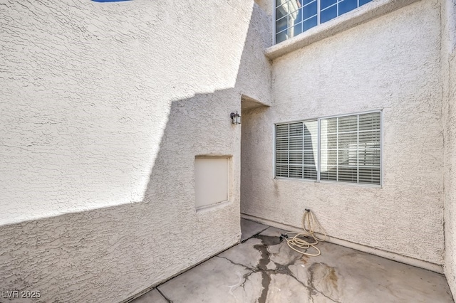 entrance to property featuring a patio