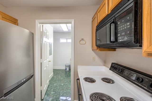 kitchen with range with electric cooktop and stainless steel refrigerator