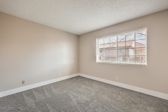 carpeted spare room featuring a textured ceiling