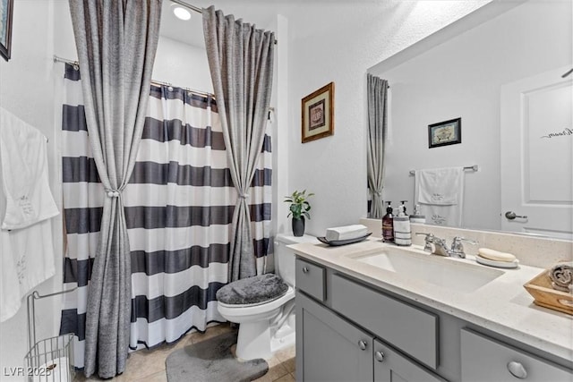 bathroom featuring vanity, curtained shower, tile patterned floors, and toilet