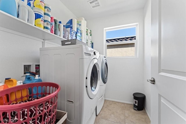 clothes washing area featuring light tile patterned floors and independent washer and dryer