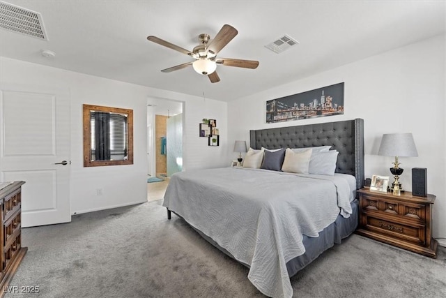 carpeted bedroom with ensuite bath and ceiling fan