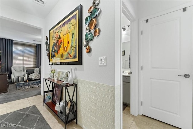 hallway featuring light tile patterned flooring