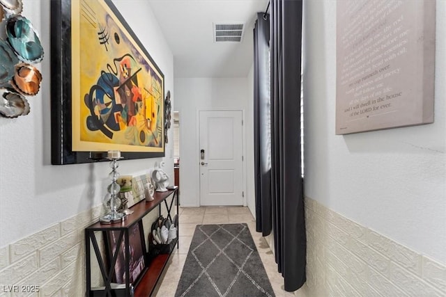 hall with light tile patterned floors