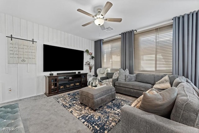 living room with ceiling fan and carpet