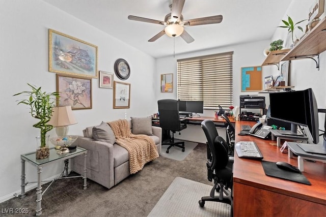 carpeted office space featuring ceiling fan