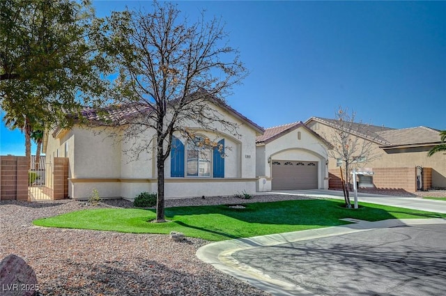 mediterranean / spanish house featuring a garage and a front yard