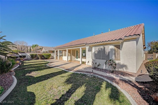 back of house featuring a patio and a lawn