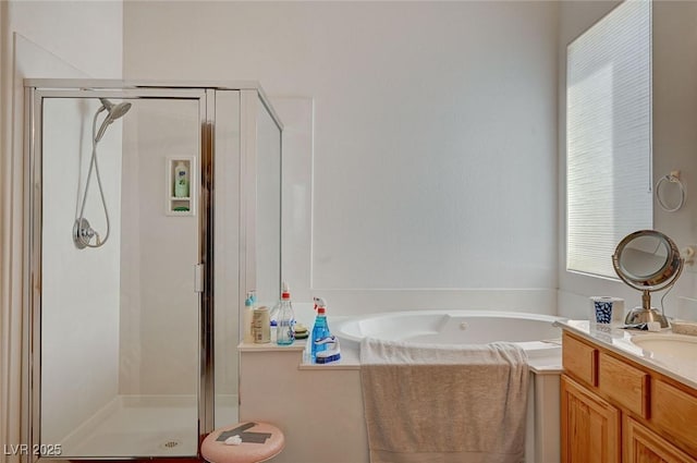 bathroom with vanity and shower with separate bathtub