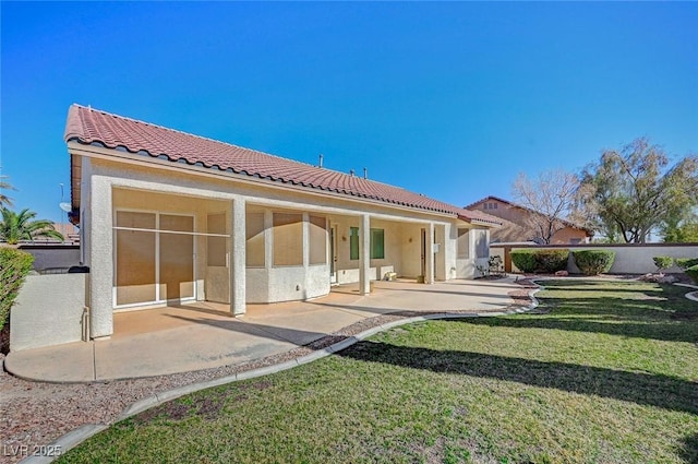 back of house with a yard and a patio area