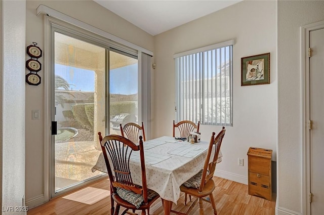 dining room with a healthy amount of sunlight and light wood-type flooring