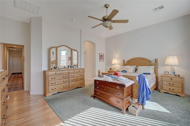 bedroom featuring lofted ceiling, ceiling fan, and light wood-type flooring