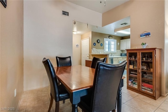 dining area with sink and light tile patterned floors