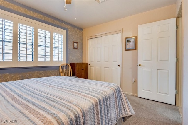 bedroom with light carpet, a closet, and ceiling fan