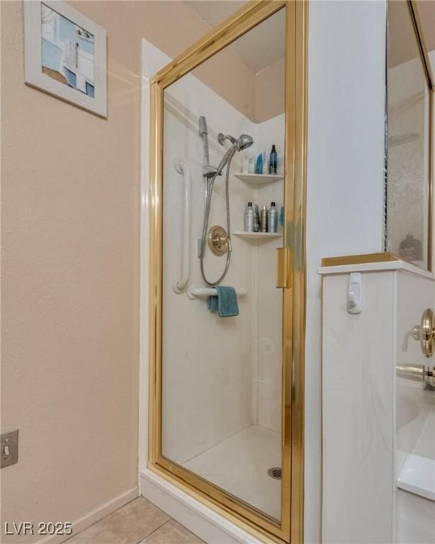 bathroom with tile patterned floors and a shower with door