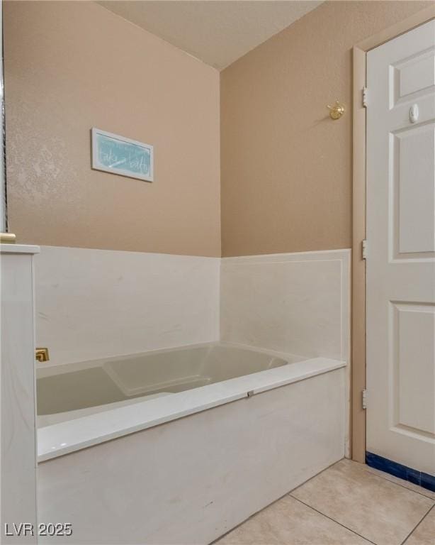 bathroom featuring tile patterned flooring and a bathtub