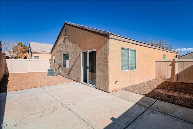 rear view of property with a patio and central air condition unit