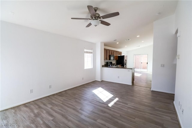 unfurnished living room with hardwood / wood-style flooring, ceiling fan, and lofted ceiling