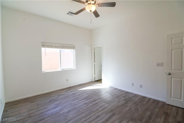 spare room with ceiling fan and dark hardwood / wood-style flooring