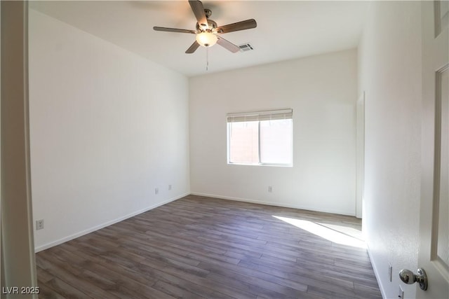 spare room with dark hardwood / wood-style flooring and ceiling fan