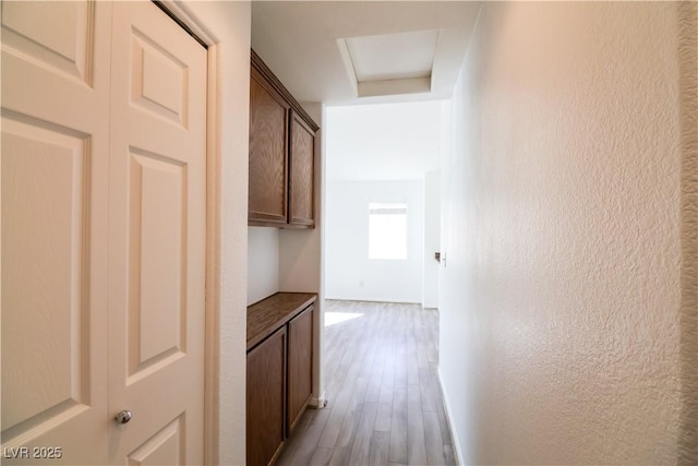 corridor with hardwood / wood-style floors