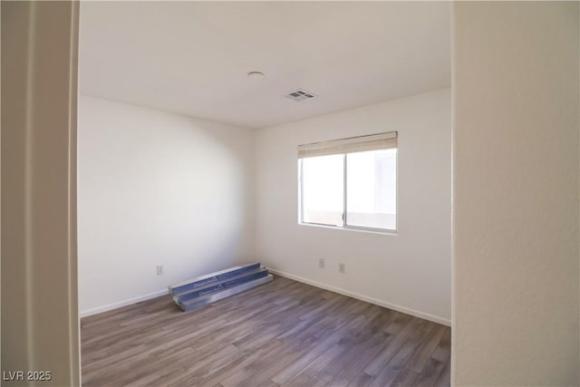 spare room featuring hardwood / wood-style flooring