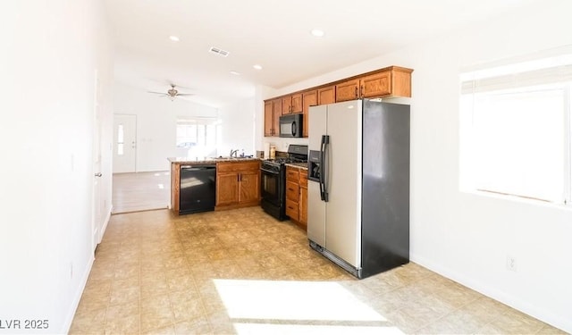 kitchen featuring sink, vaulted ceiling, kitchen peninsula, ceiling fan, and black appliances