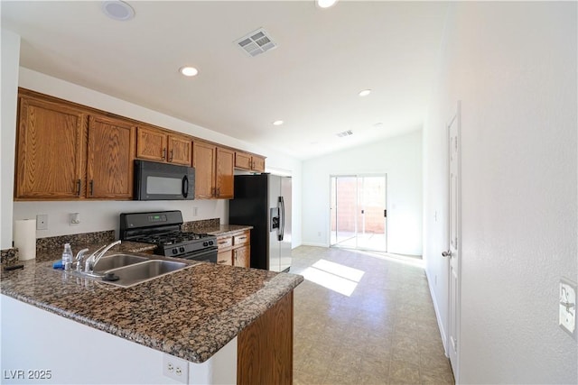 kitchen with lofted ceiling, sink, black appliances, and kitchen peninsula