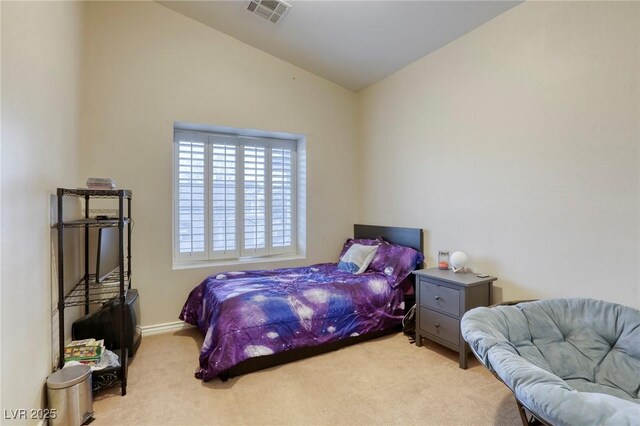 carpeted bedroom with vaulted ceiling