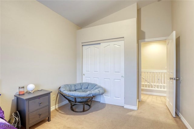 sitting room with lofted ceiling and light carpet