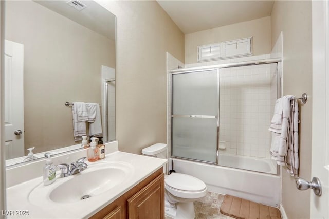 full bathroom with vanity, enclosed tub / shower combo, and toilet