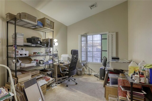 carpeted office space featuring lofted ceiling