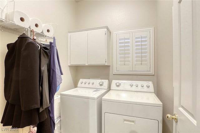 laundry room with cabinets and washing machine and clothes dryer