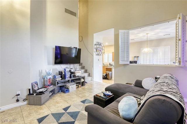 tiled living room with a high ceiling