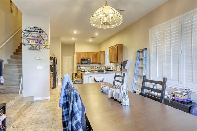 dining space featuring light tile patterned flooring and an inviting chandelier